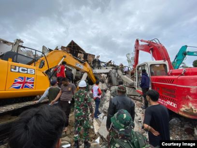 Dua alat berat excavator membatu upaya evakuasi korban yang terjebak di bawah reruntuhan kantor Gubernur Sulbar yang roboh, Jumat (15/1/2021) (Foto : Taufiq Lau/ Pemprov Sulsel).