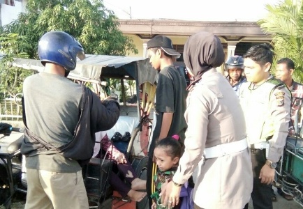 Kasat lantan polresta Langsa (berhijab) saat melakukan pertolongan kepada korban yang mengalami Laka. FOTO : ROBY SINAGA