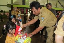 Sekretaris Daerah (Sekda) Ir. Sholih, MM saat menyerahkan sebuah tropy kepada salah satu anak yang menjadi pemenang lomba di Hari Anak Nasional. FOTO : DSW