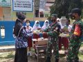 Babinpotmar pos TNI AL dan Babinsa Koramil Karimunjawa menyerahkan buku ke SD